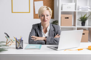AML Compliance Officer reviewing suspicious activity reports on a computer screen in a modern office.
