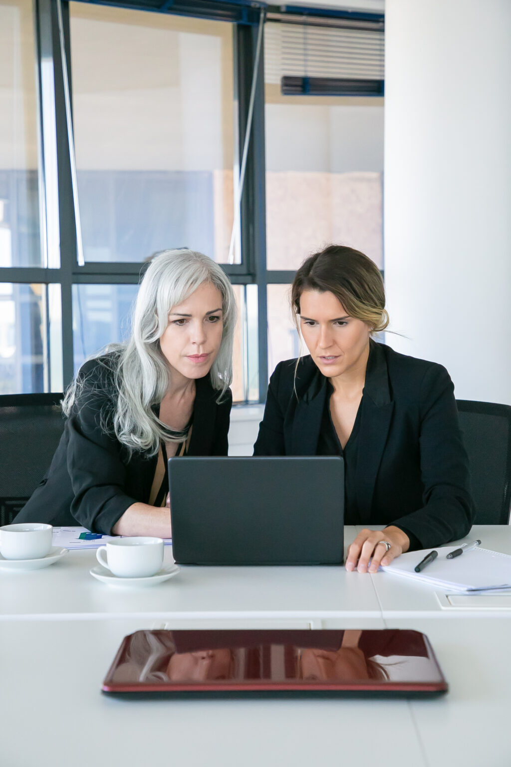 Business professionals using technology to manage compliance as a service in real time