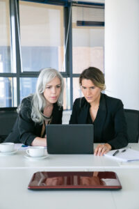 Business professionals using technology to manage compliance as a service in real time