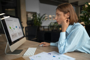 KYC analyst reviewing documents with AI software in a bank